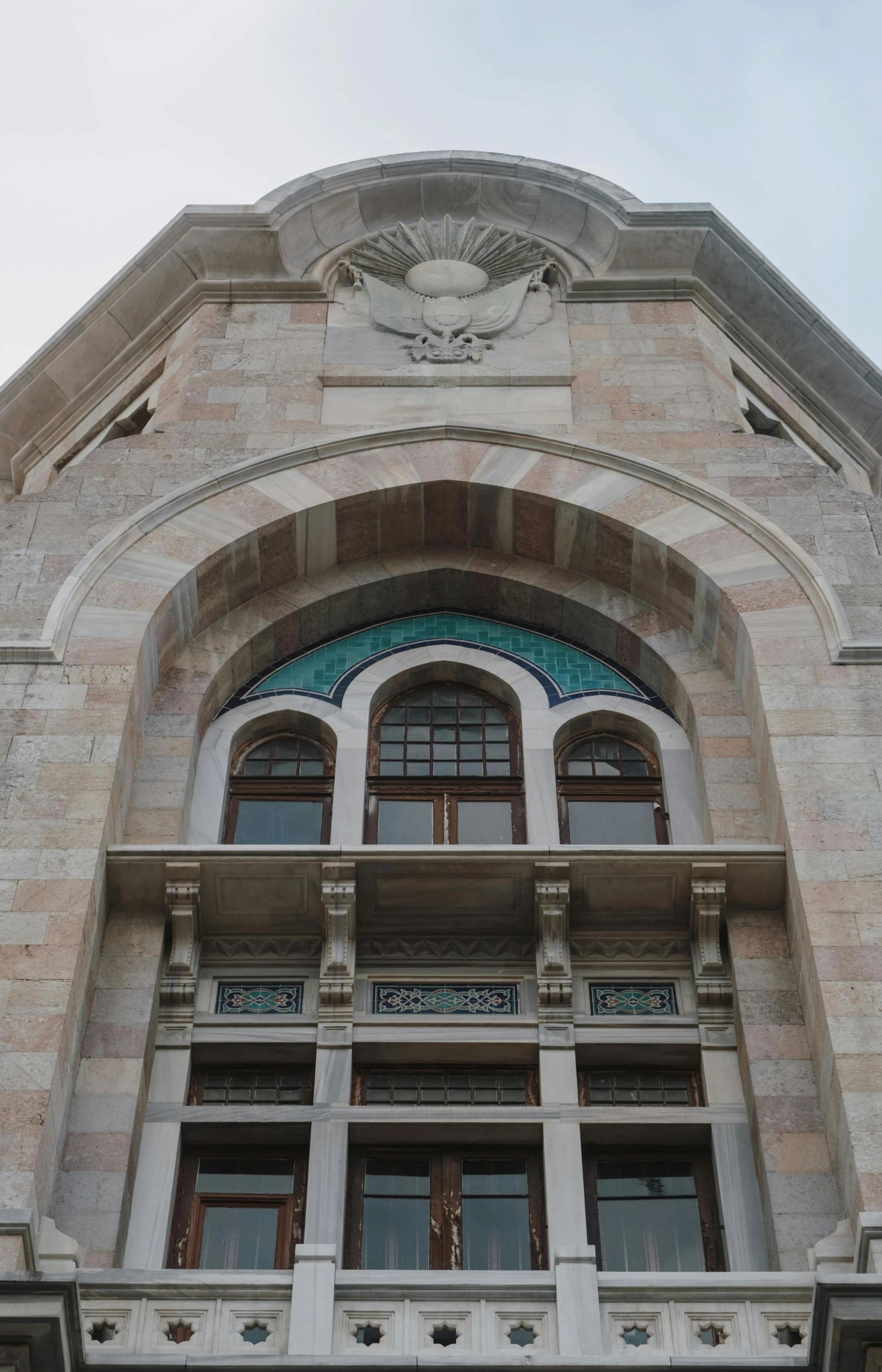 an arched window overlooks a decorative building