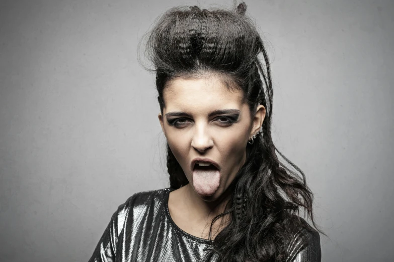 a woman sticking her tongue out with long hair