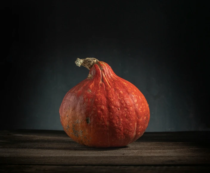 a large orange and a few other oranges on a table