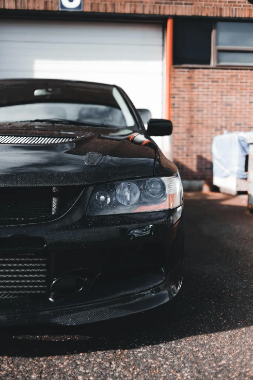 black car parked in a driveway near garage