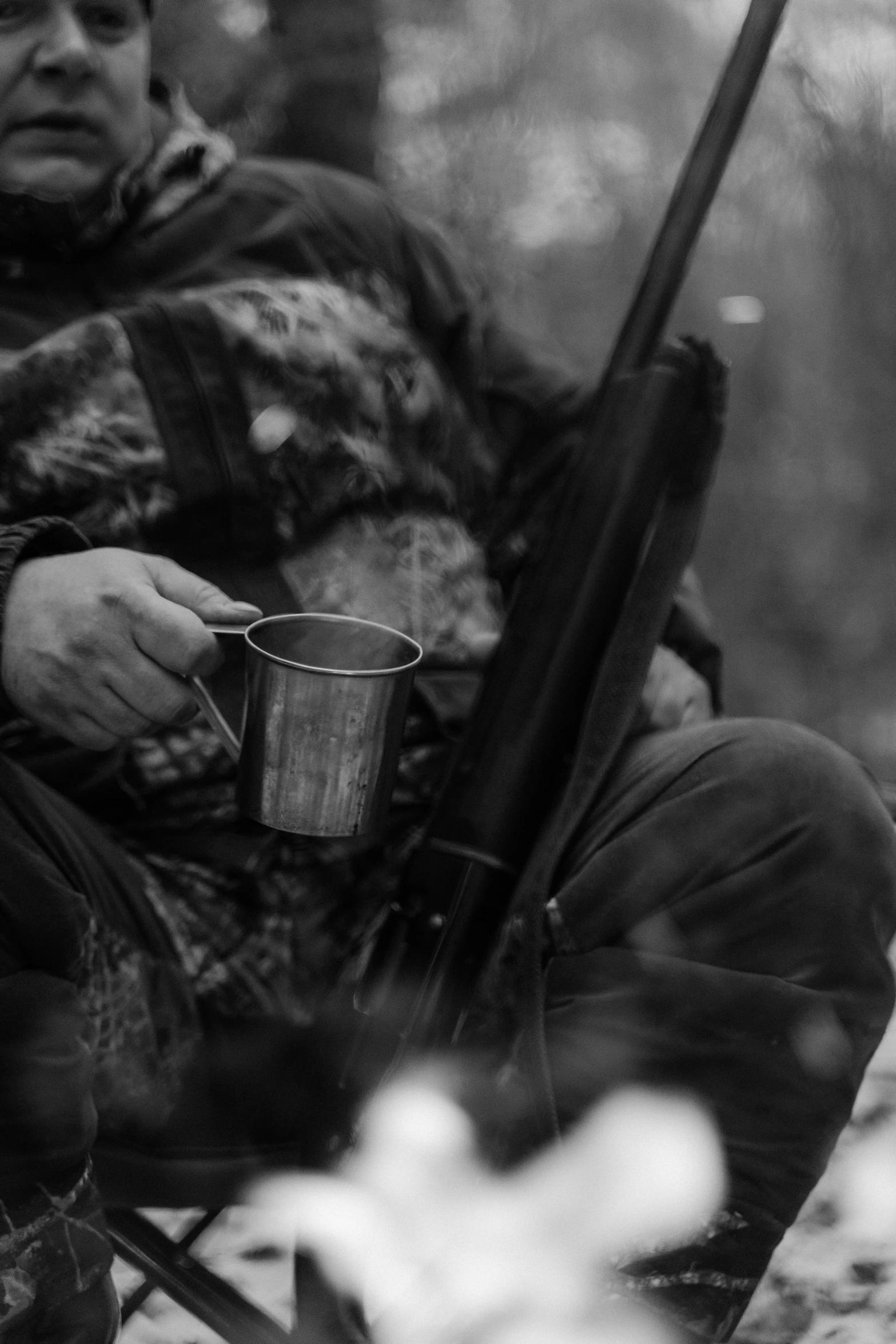 a black and white po of a person with a cup