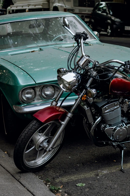 the front of a motorcycle that is parked in front of a car