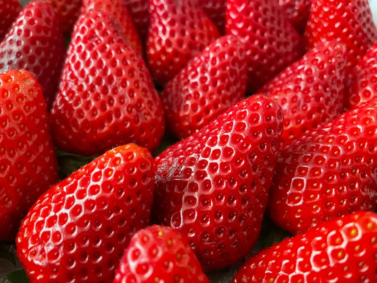 a pile of red strawberries piled up with each other