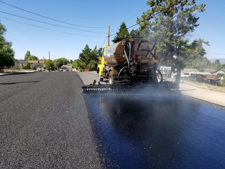 a truck driving on a wet road during the day