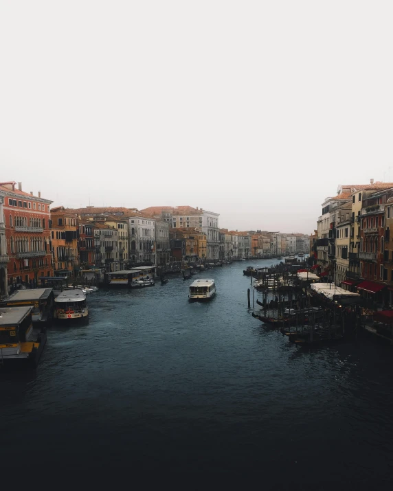 a canal with several boats and buildings in the water