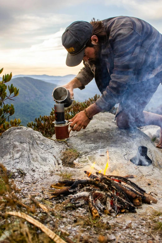 a man is cooking soing on the ground