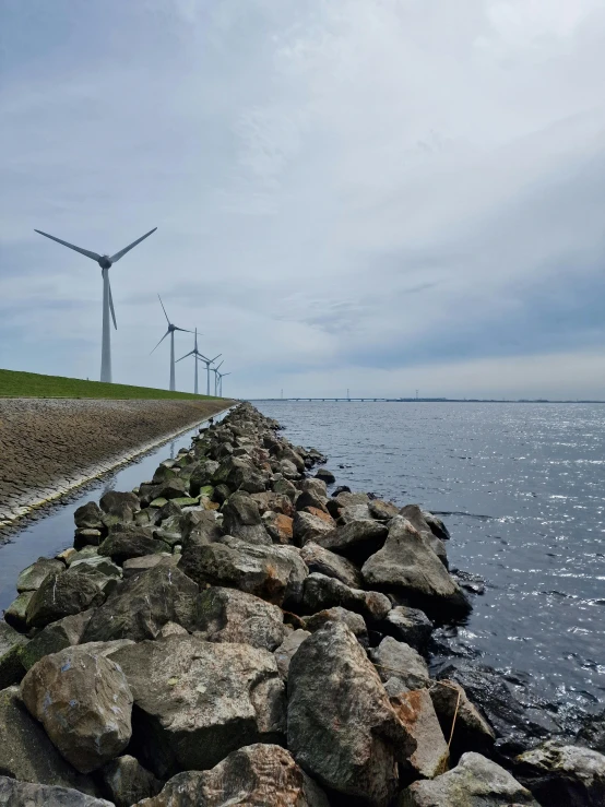 wind mills near the sea on an overcast day
