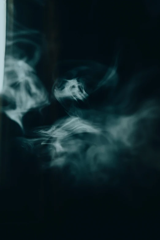 smoke is over the edge of a white vase