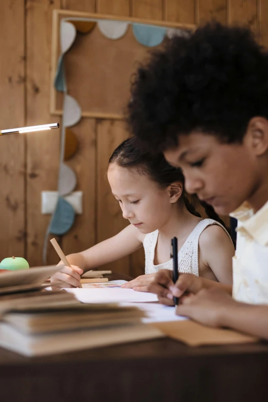 a couple of s doing homework at a table