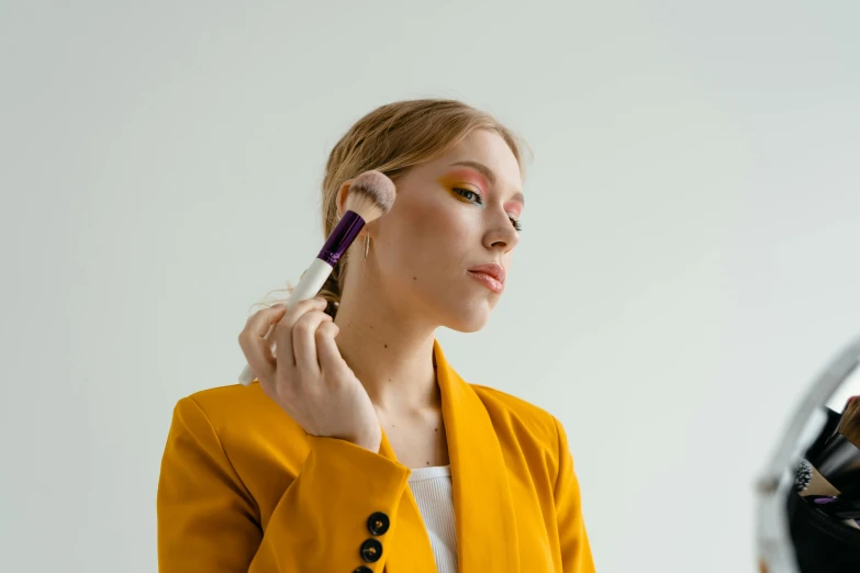 a woman is putting on makeup while taking her own own image