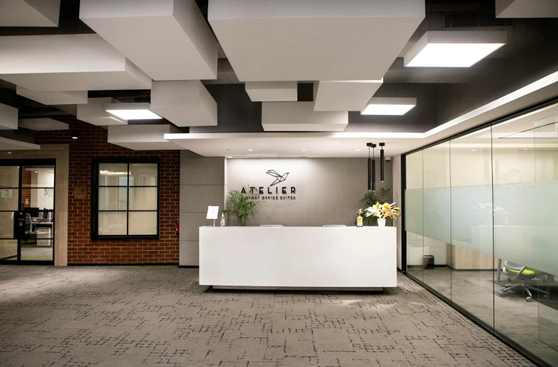 an office lobby with a bar and a reception desk