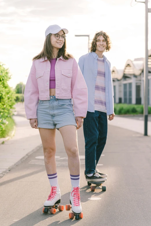 two people on skateboards riding down a street