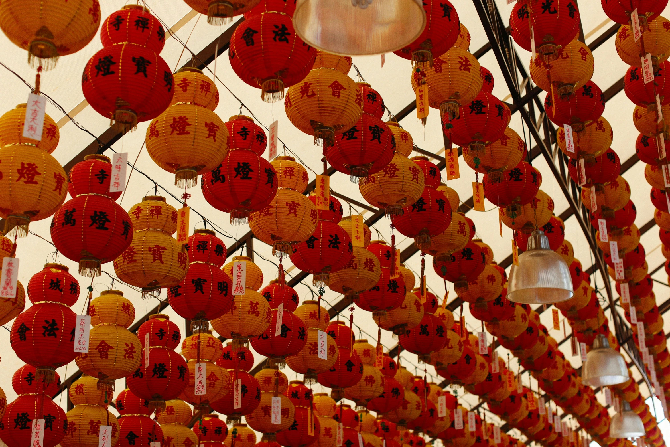 several red and white lanterns hanging on the ceiling