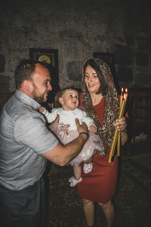 a man, woman and baby pose for a picture