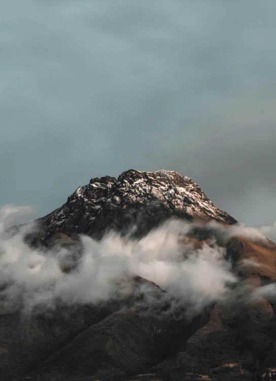 an image of a snowy mountain in the clouds