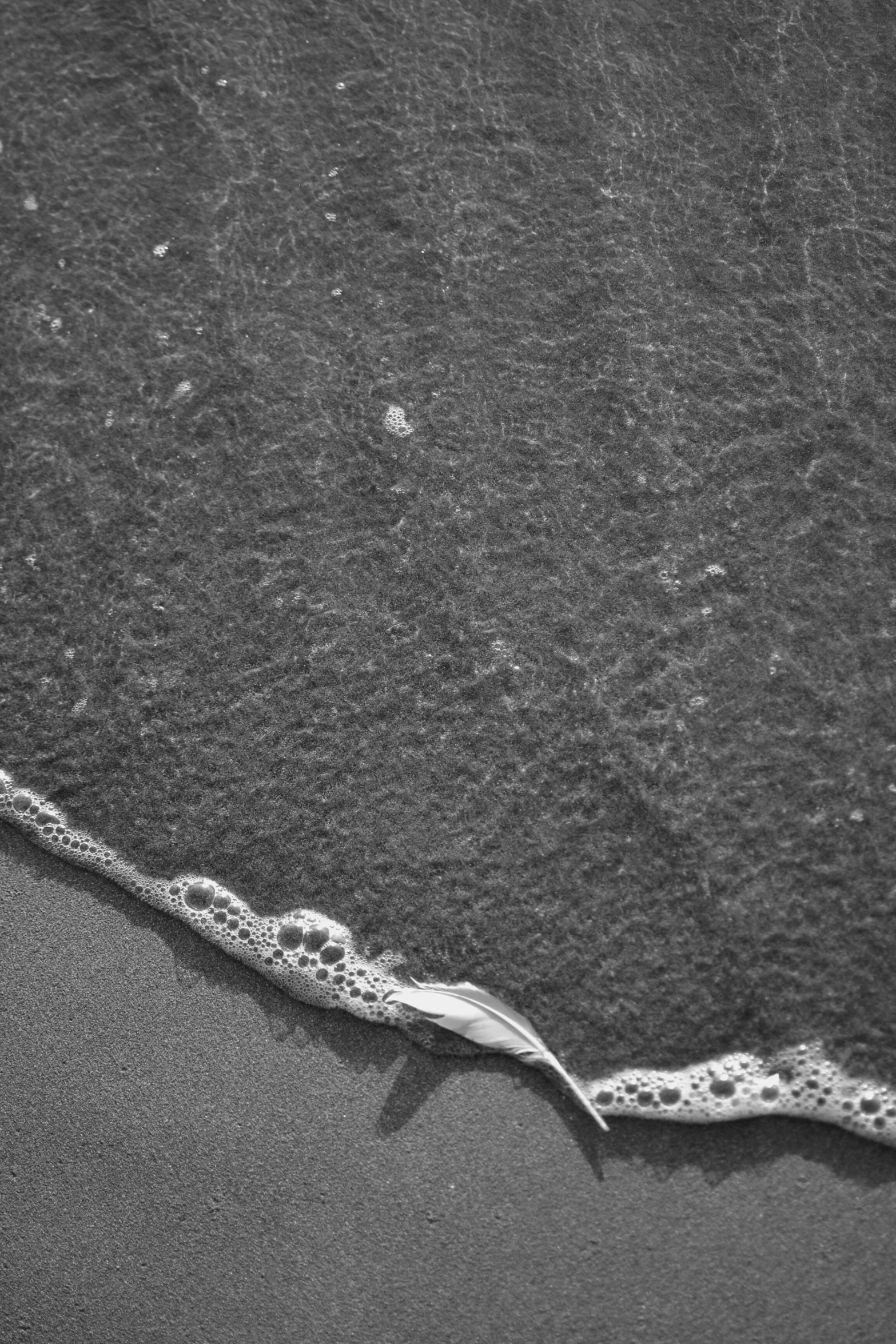 a close up of a wave breaking on the beach