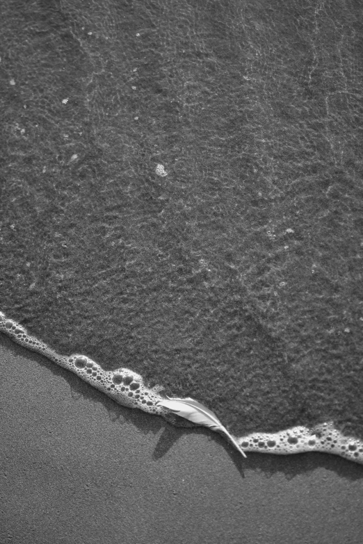 a close up of a wave breaking on the beach