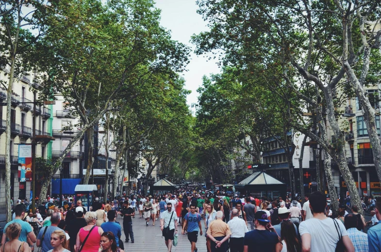 a crowd of people walking down a city street