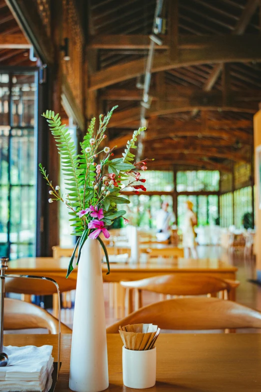 flower arrangement in the middle of an outdoor table at a restaurant