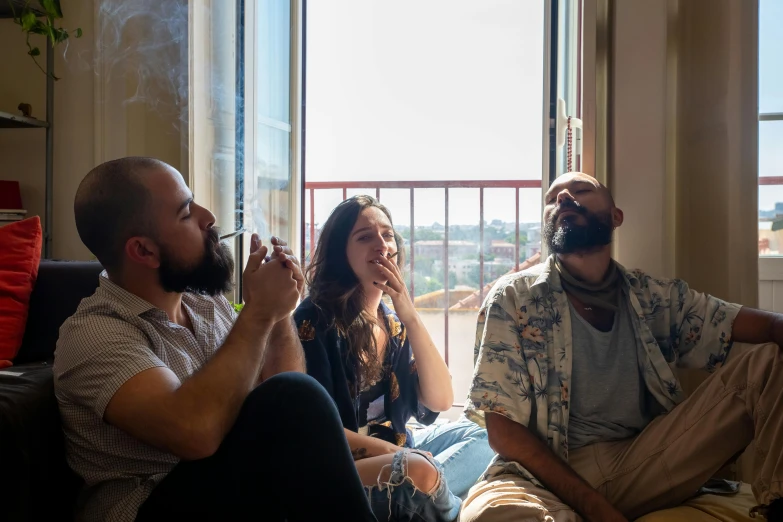 four people talking and drinking at a window