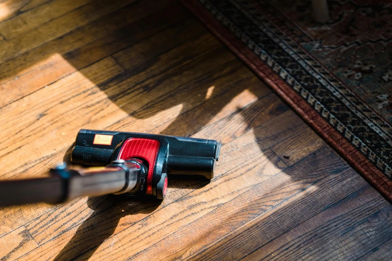closeup view of a cordless drill tool on wooden floor