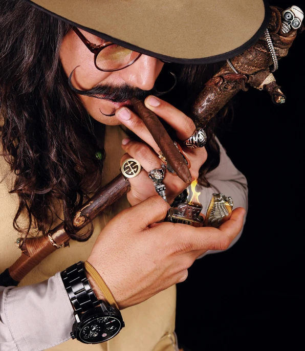 a man in a cowboy hat holding some cigars