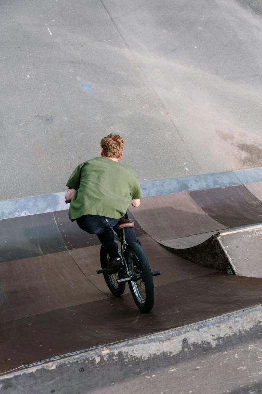 there is a young man riding a bike on the street