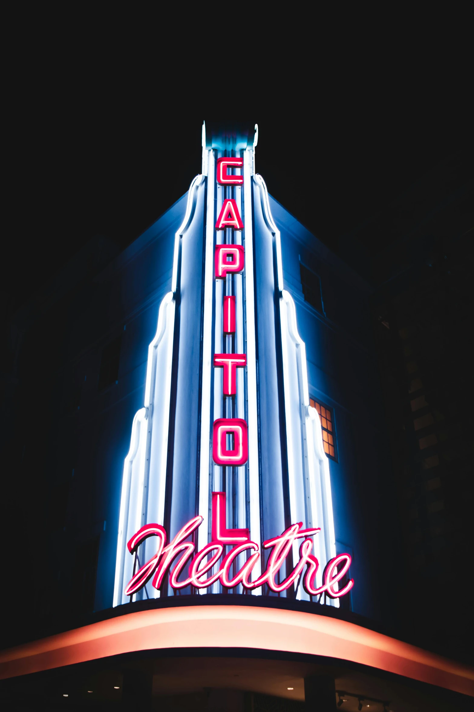 a theater sign sits out side at night