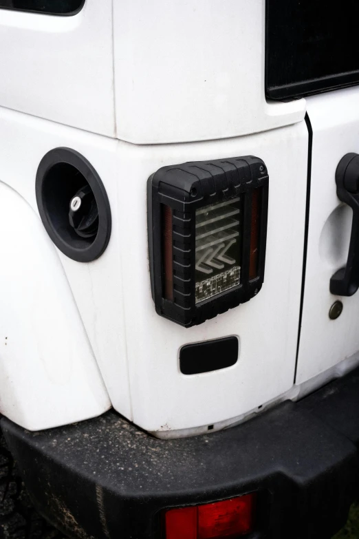 the back end of a white truck with speakers