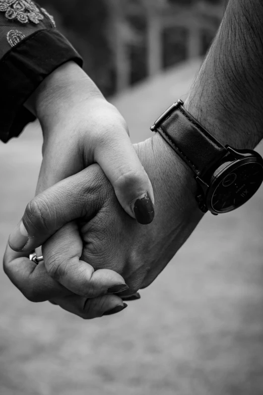 a man and woman holding hands while holding hands