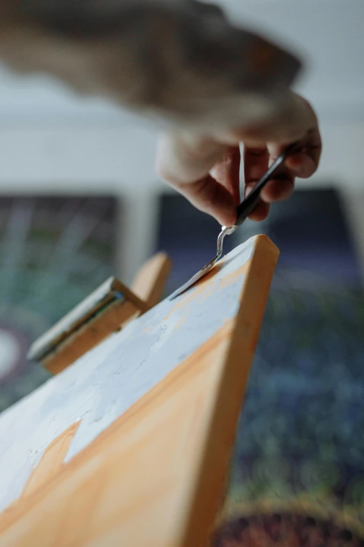 an artist doing a painting on canvas with his hand