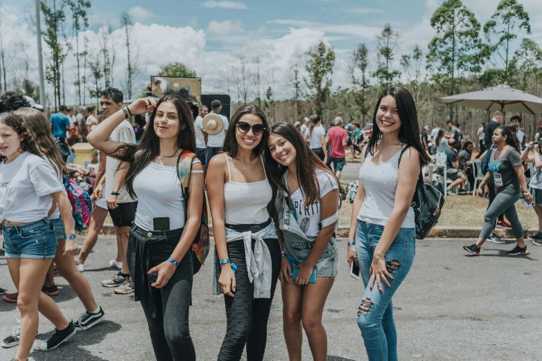 group of young women posing for picture at the festival