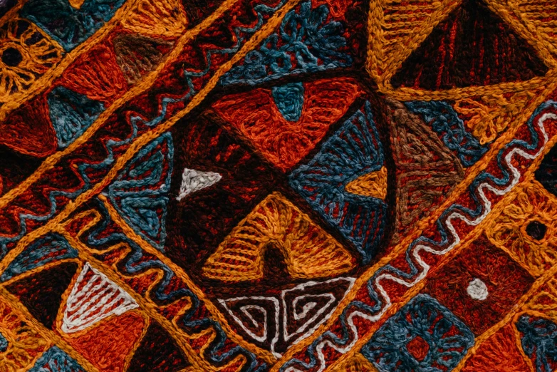 a knit blanket with designs that is orange