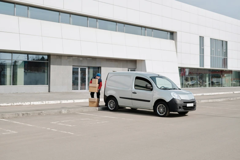 a person stands next to an empty white van