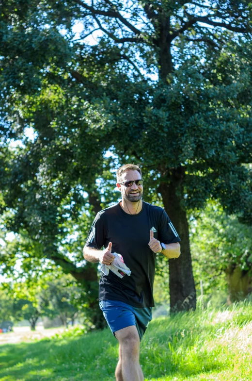 a man in glasses is running on a path