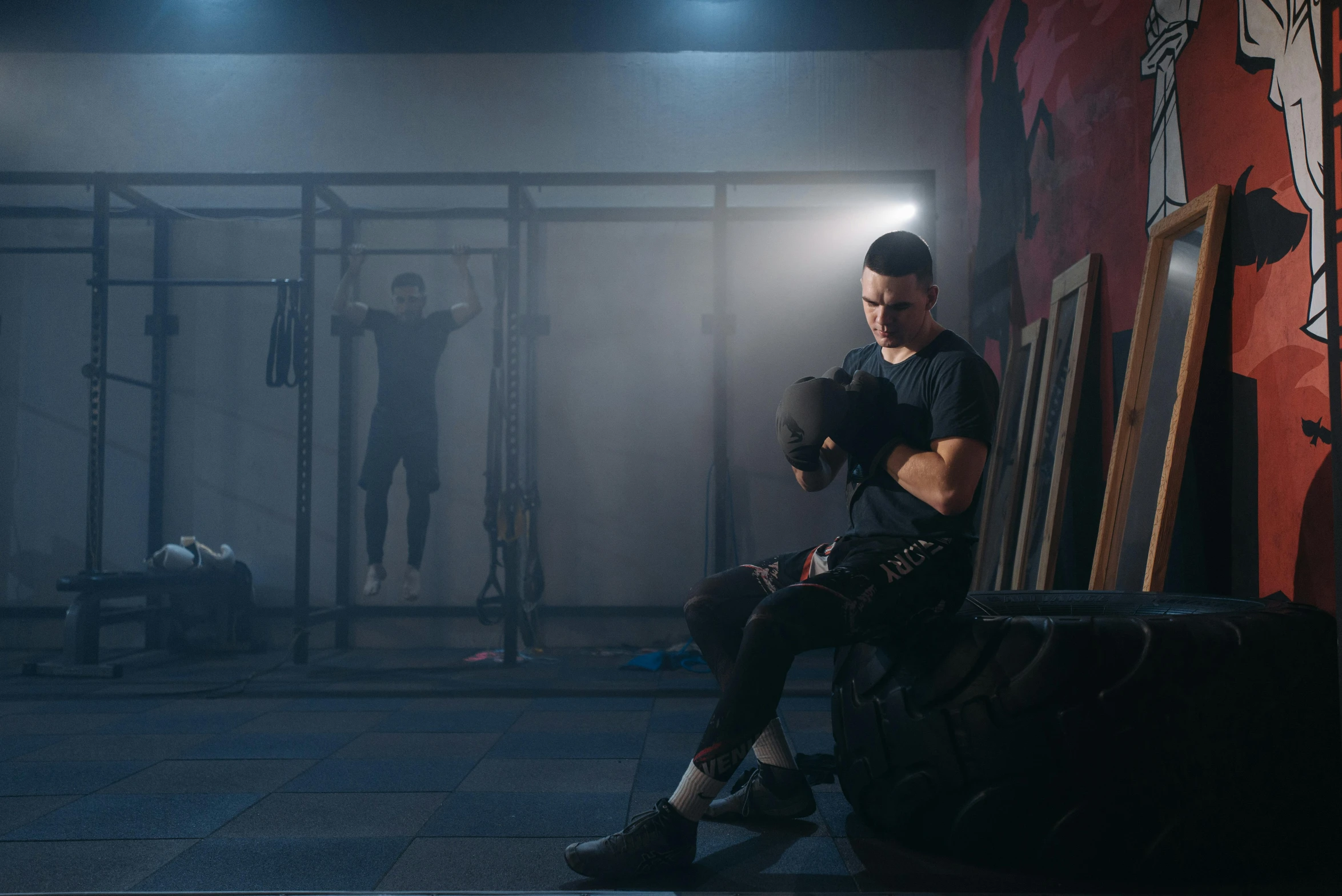 a man sitting on top of a chair wearing all black