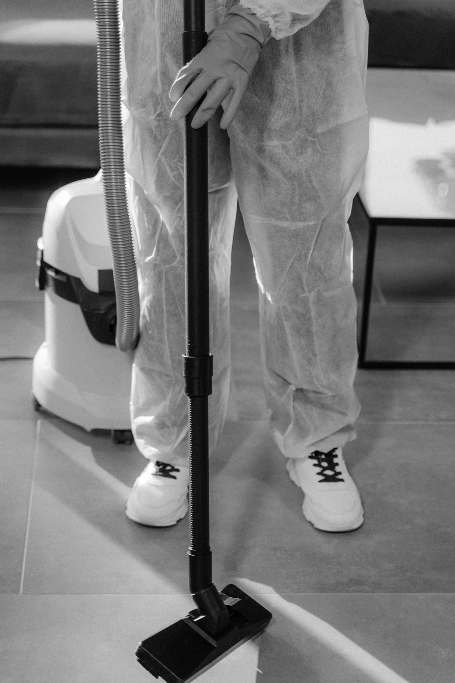 black and white pograph of a woman standing on top of a duster