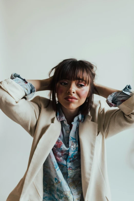 a woman with her hands behind her head posing for a po