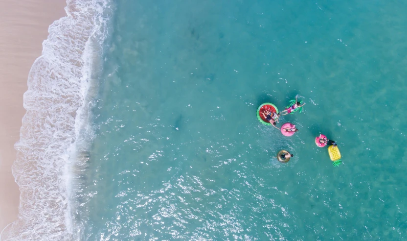 two kayaks in the water, one with a yellow raft and one with a red paddle