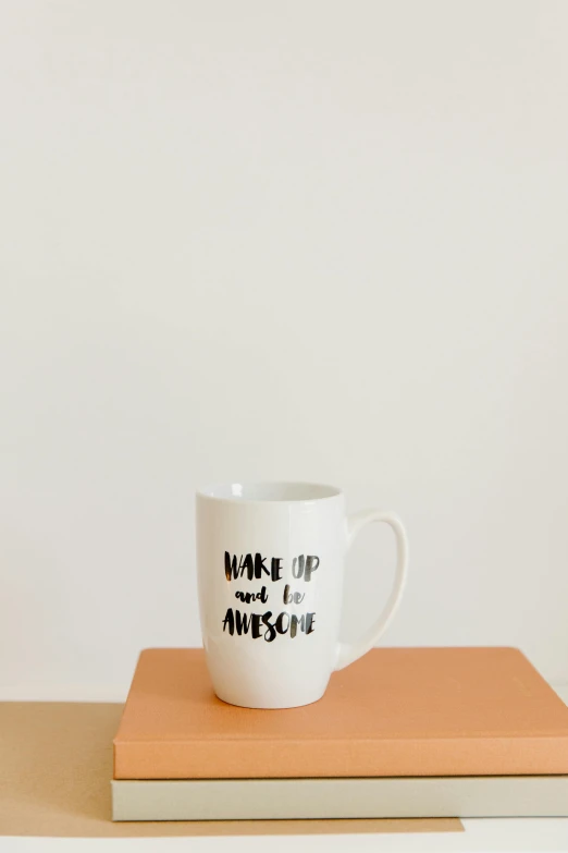 a coffee mug sitting on top of a book