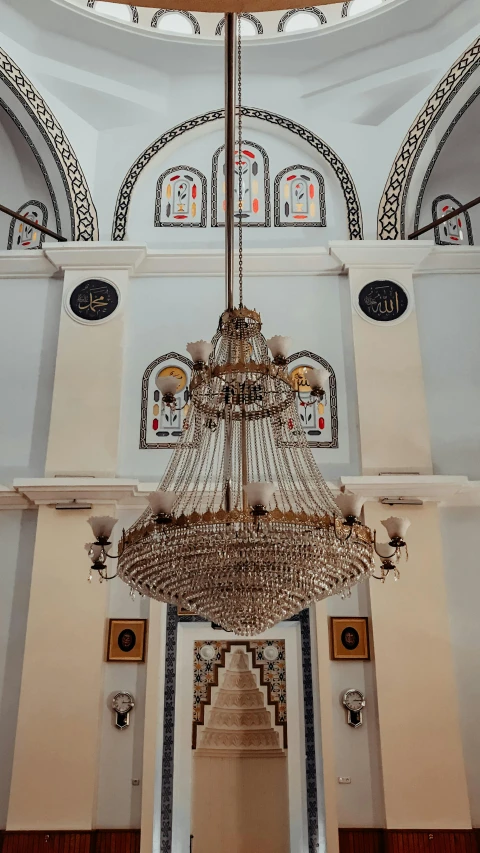 a chandelier hangs from the ceiling of an ornately decorated building