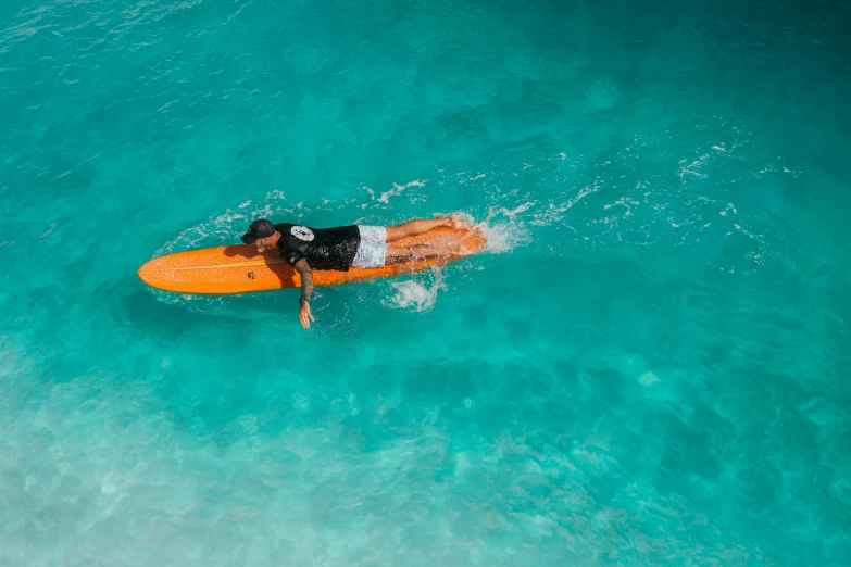 there is a man that is riding on his surfboard