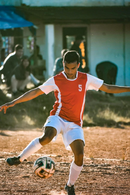 a soccer player is about to kick the ball