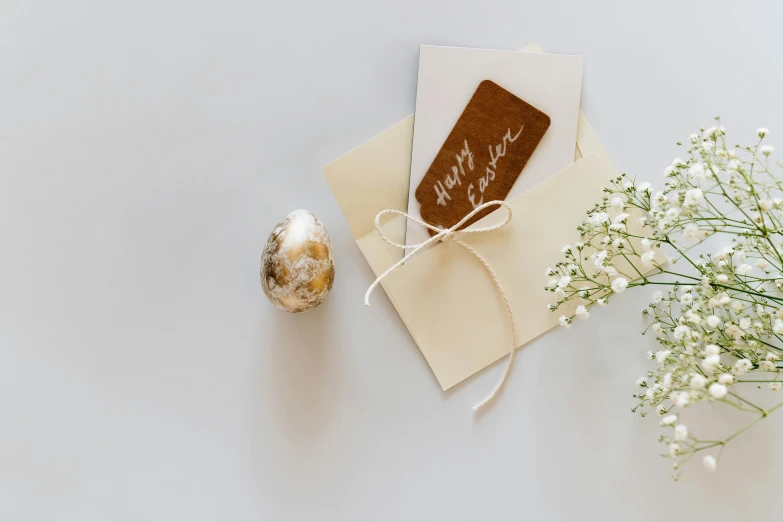 a table with a small flower vase and a card