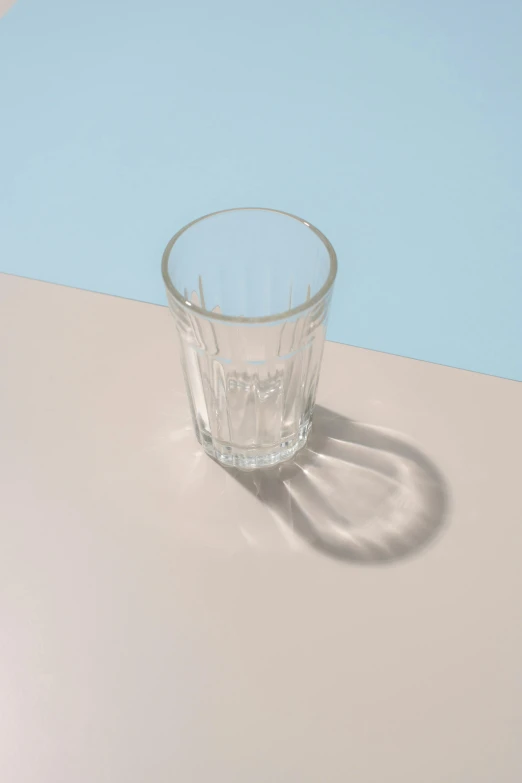 a clear glass with a white shadow on it