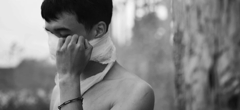 a young man with white scarf on his neck