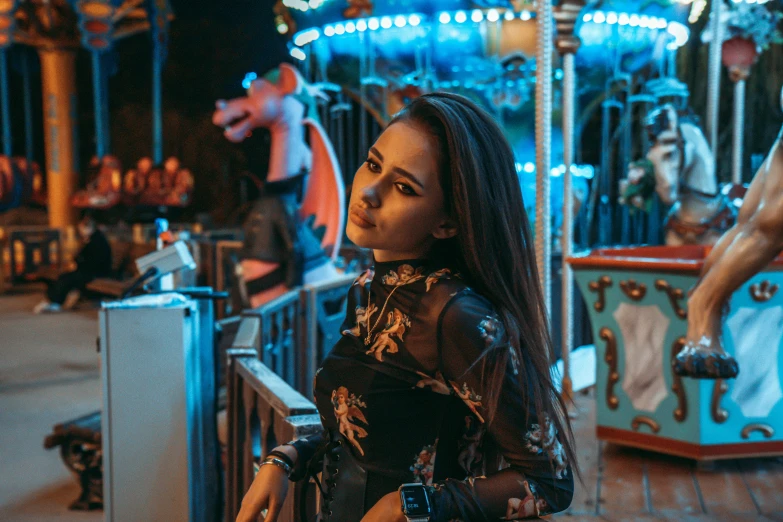 young lady in leather dress standing by carousel ride