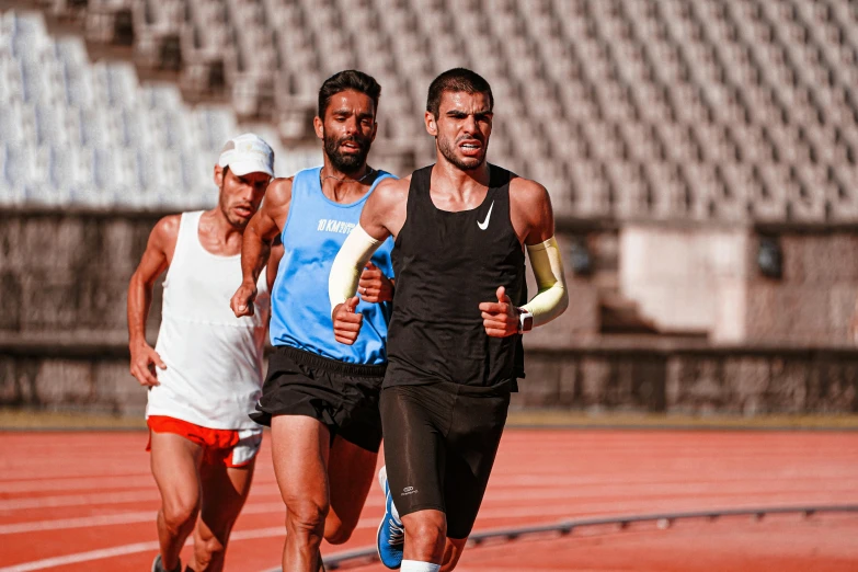 two runners run along the track on the sidelines