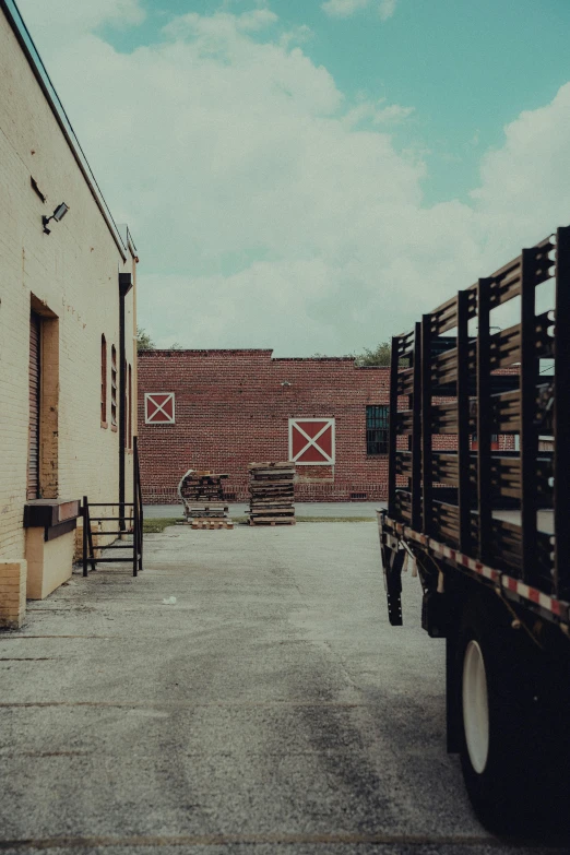 two trucks parked next to each other outside a brick building