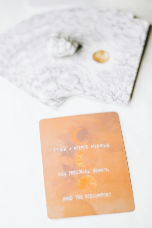 an old card sitting on a table with silver and glassware